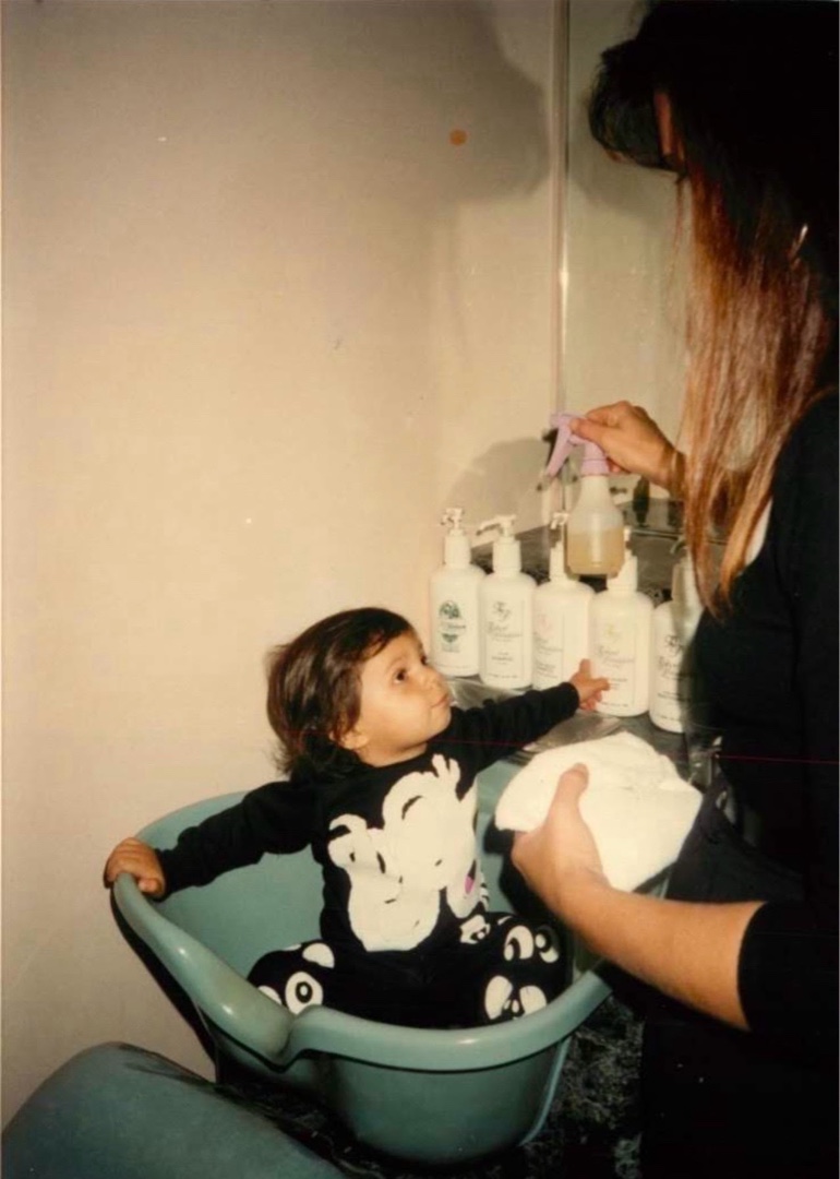 Alexi DiLella — Robert Sr.'s granddaughter — sitting in the shampoo bowl at Robert of Philadelphia, Naples, FL. She practically grew up in the salon.