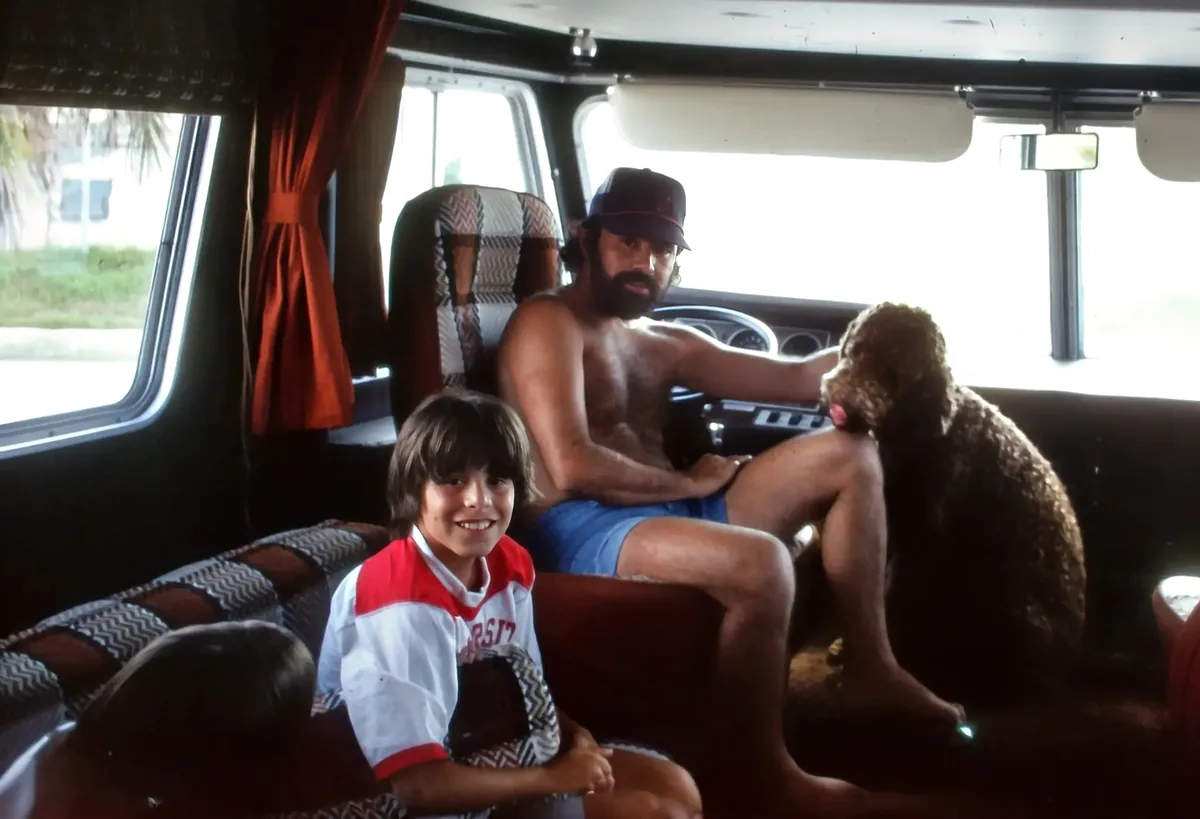 Robert DiLella Sr. inside the Vogue motorhome with his son Robert Jr. and their dog — Naples, Florida, circa 1977.